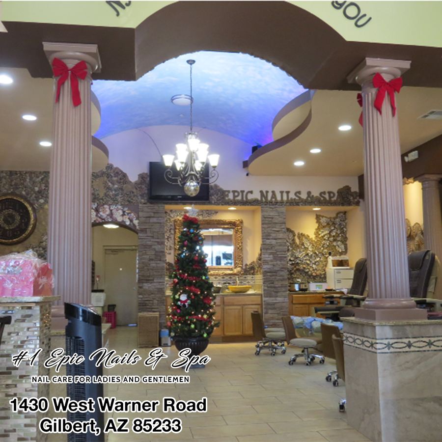 Inside the salon with columns, a chandelier and pedicure chairs