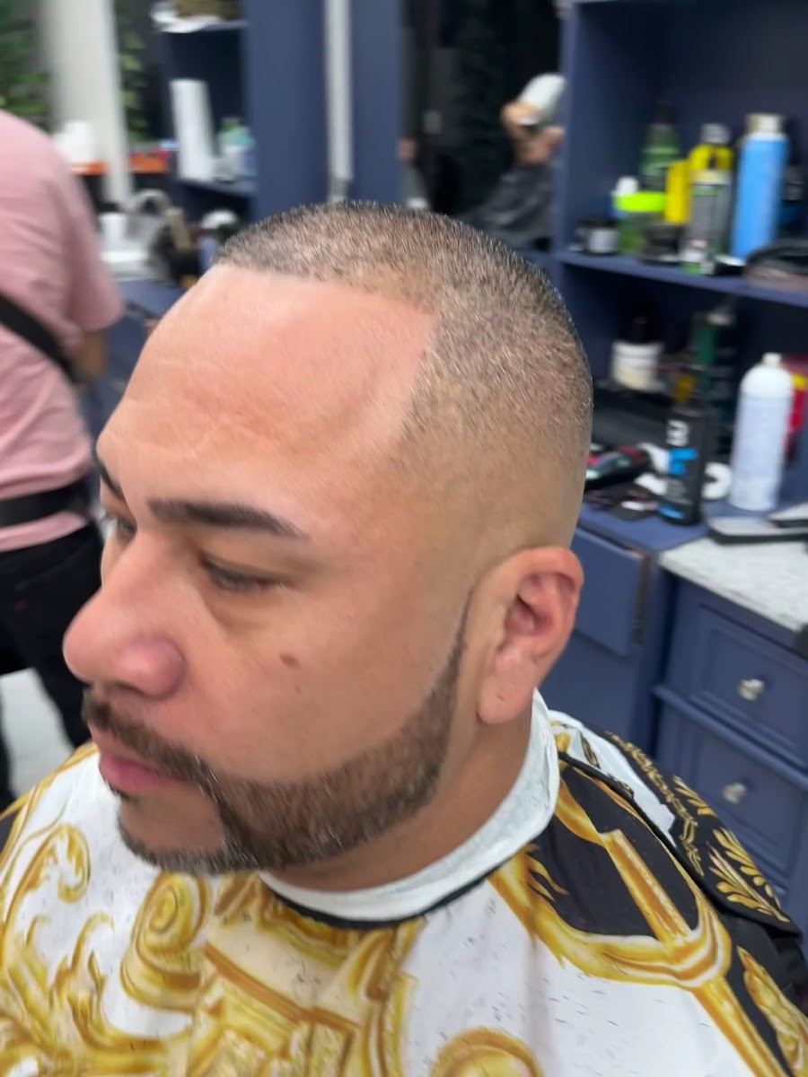 Client with a short buzz cut, crisp line up and shaped full beard