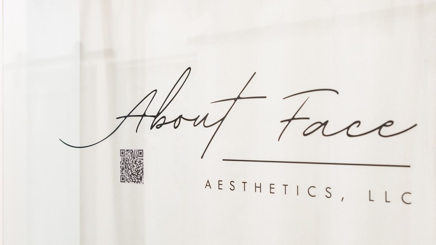 About Face Aesthetics script sign on the suite wall