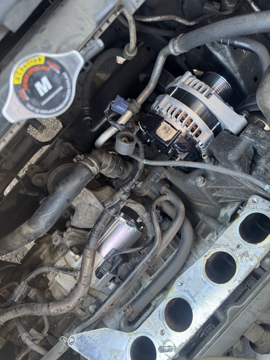 Engine bay with radiator cap, alternator and intake