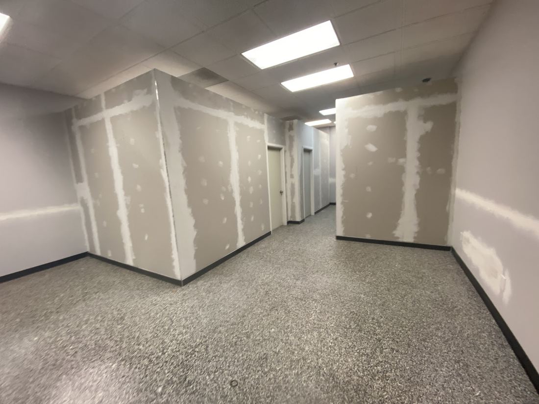Hallway with new drywall taped and mudded