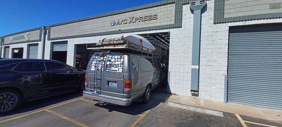 Auto A/C Xpress storefront with a van pulled into the open bay