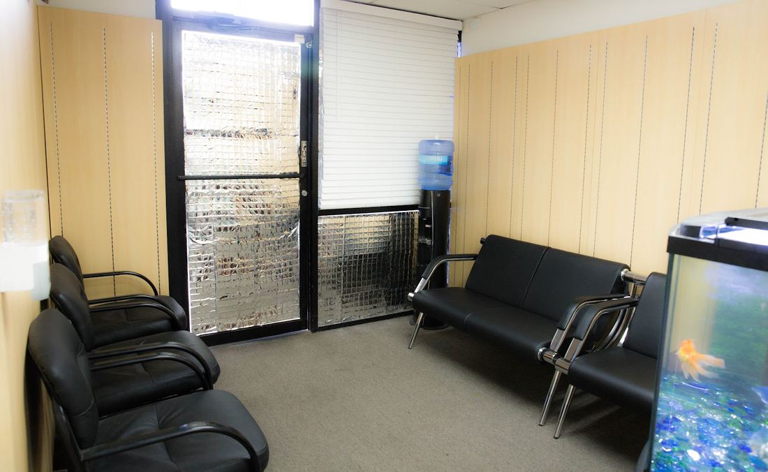 Waiting area with leather chairs and a fish tank