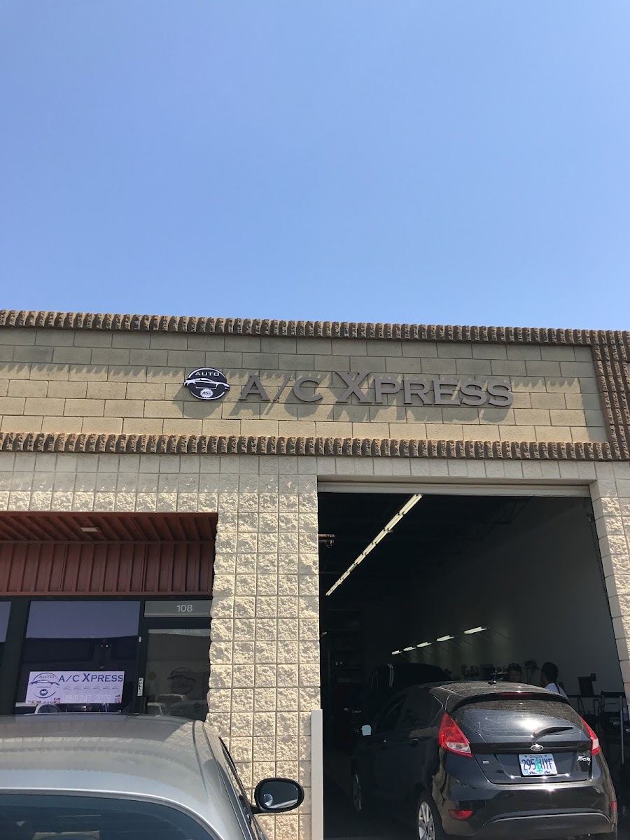 A/C Xpress sign above the open garage door