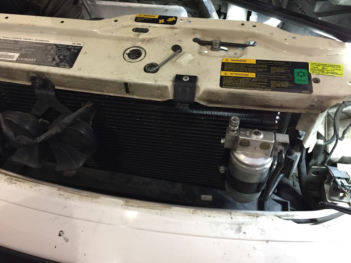 A/C condenser and lines under the hood of a white work van