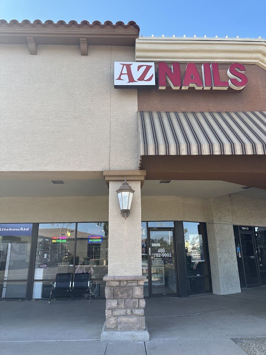AZ Nails storefront with red channel-letter sign and striped awning