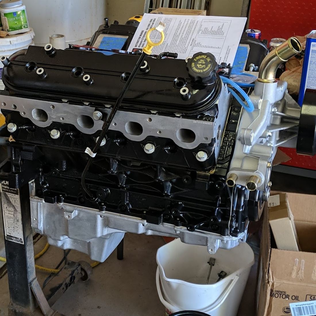 Clean V8 engine block on a stand with new parts