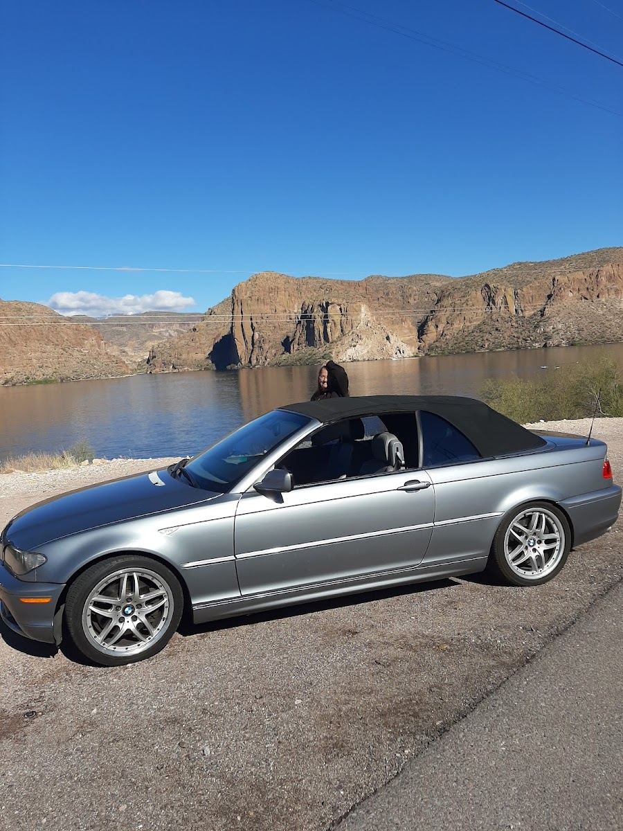 Silver convertible parked by a desert lake