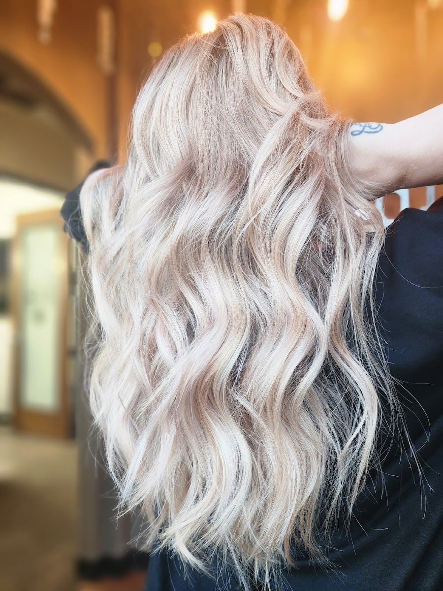 Long bright blonde waves seen from behind