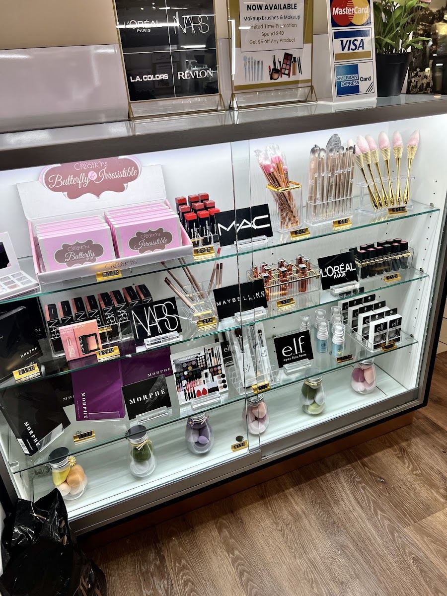 Lit glass display case with beauty products