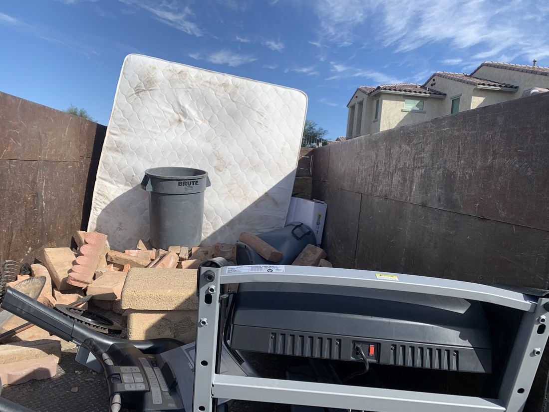 Old mattress, trash can and broken pavers loaded in the truck