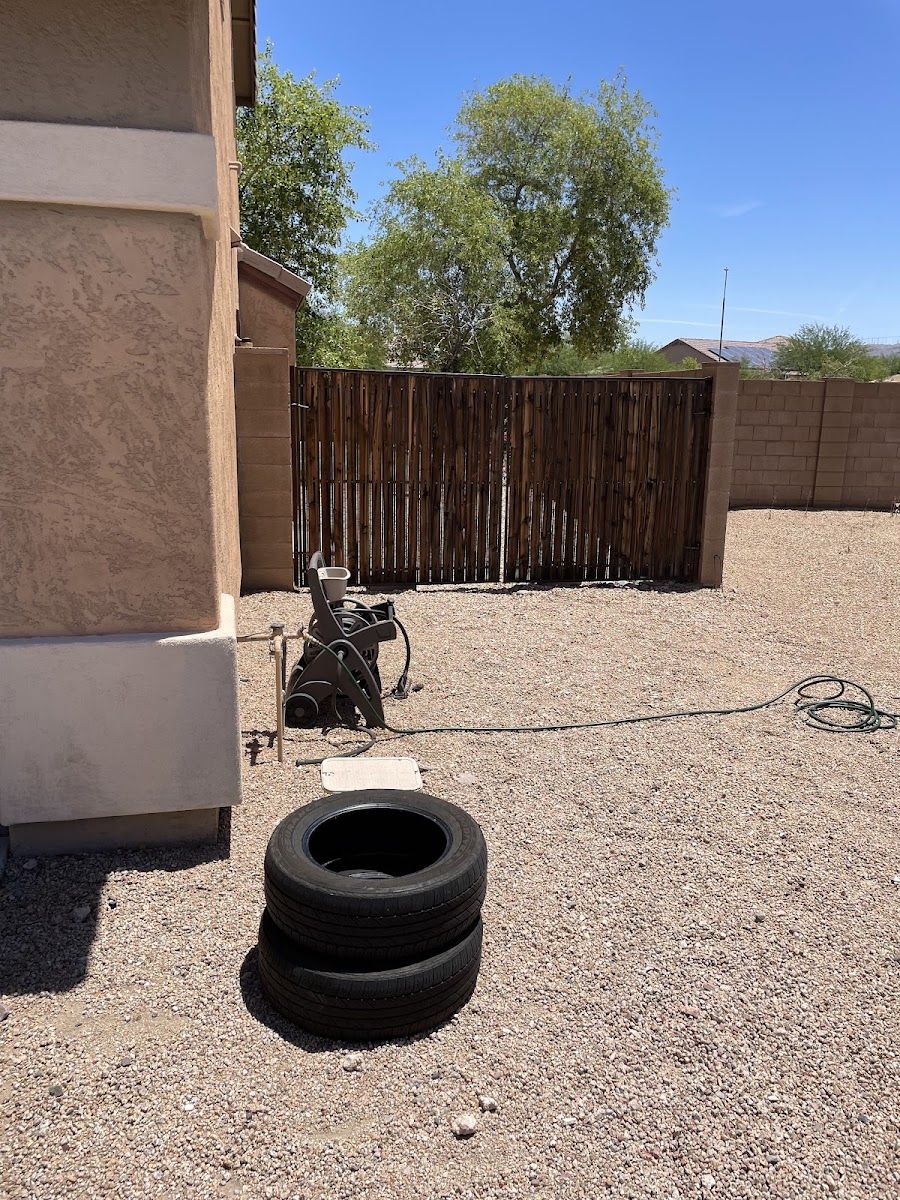 Old tires left in a gravel side yard