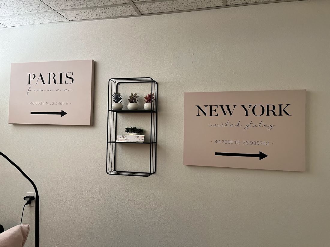 Paris and New York signs on the studio wall