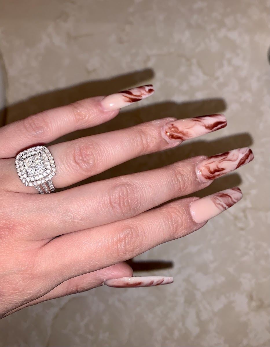 Nude nails with copper marble swirls