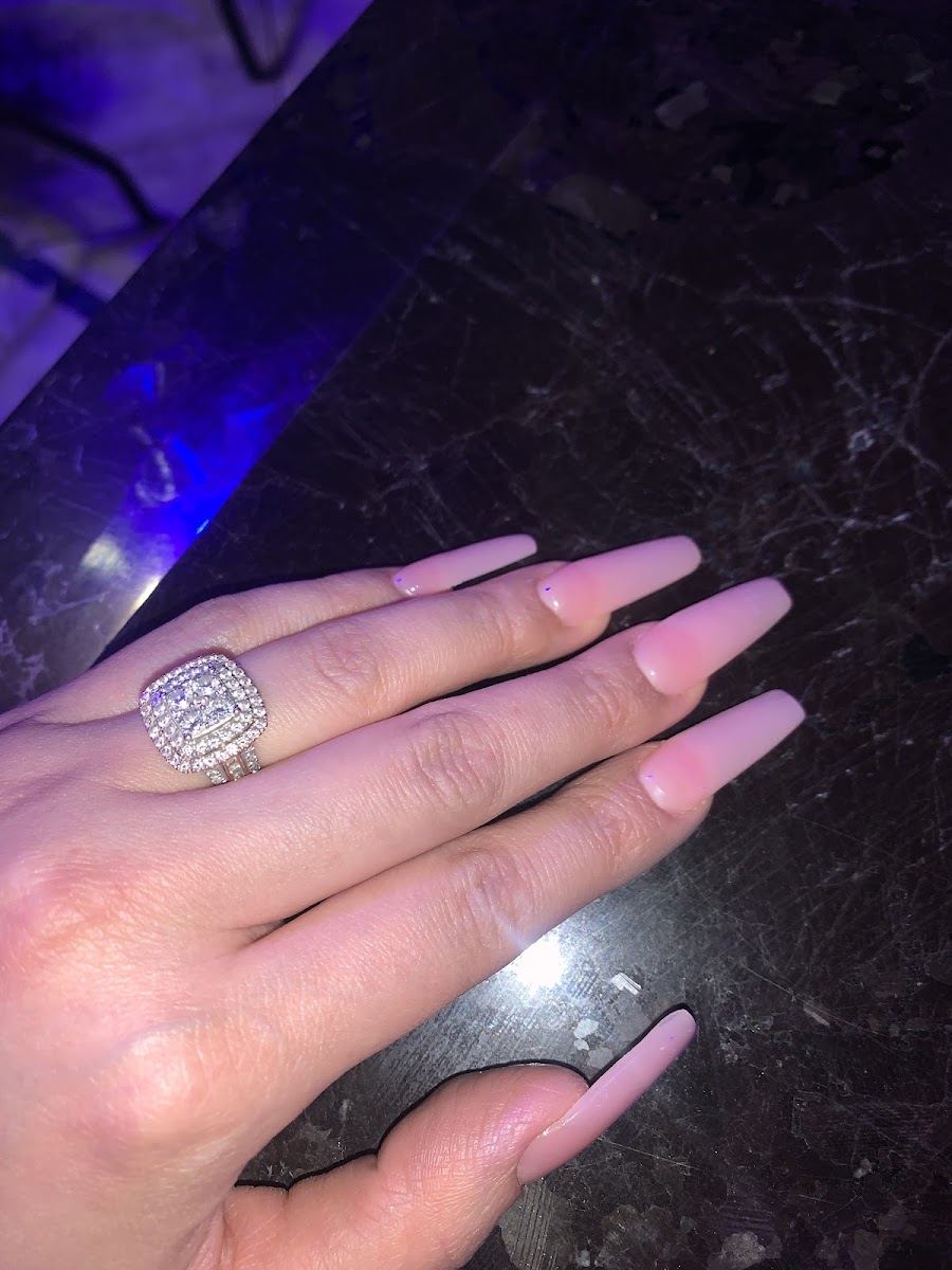 Long pink coffin acrylics with a sparkling ring