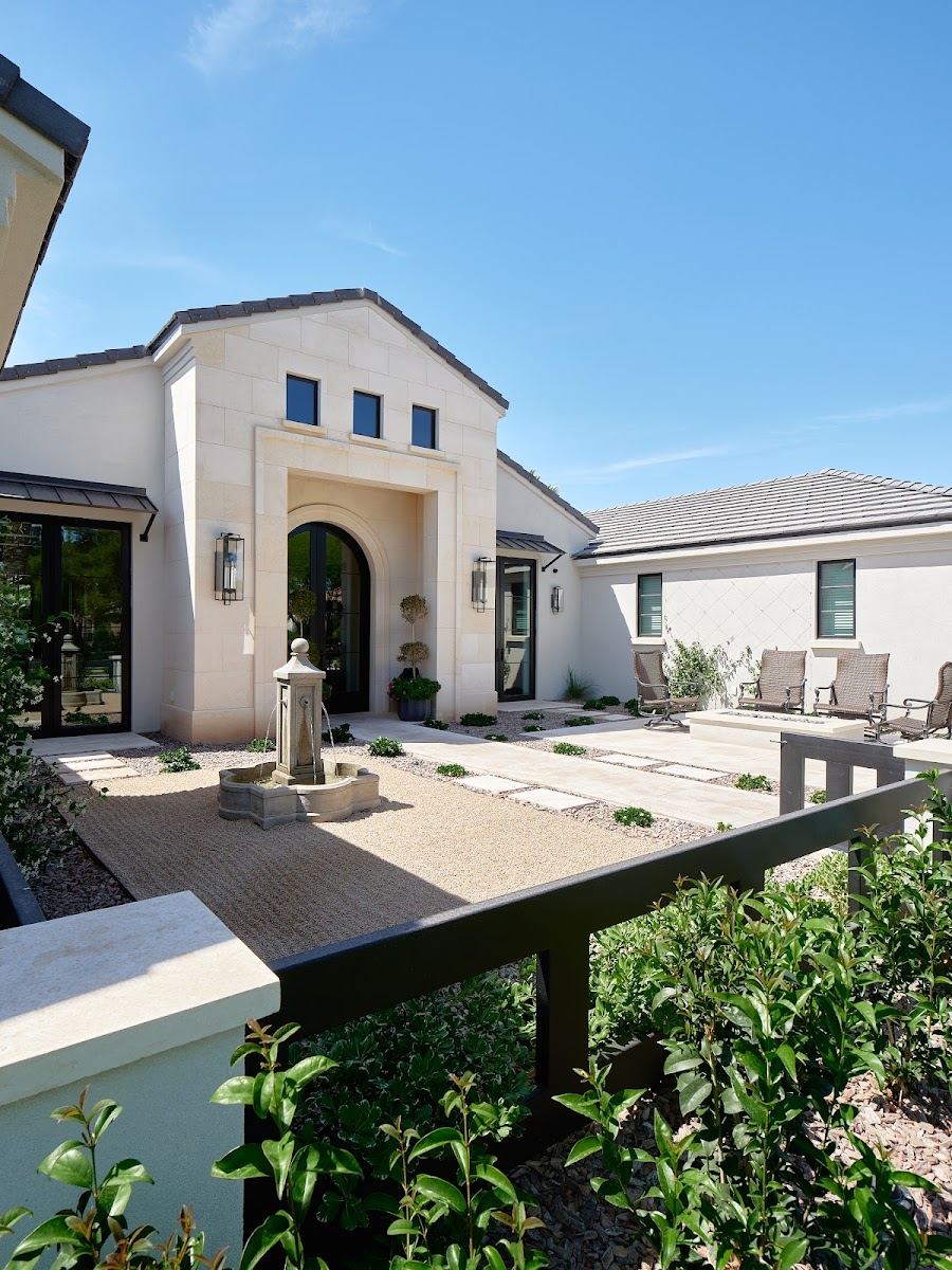 Front entry with a paver courtyard and fountain