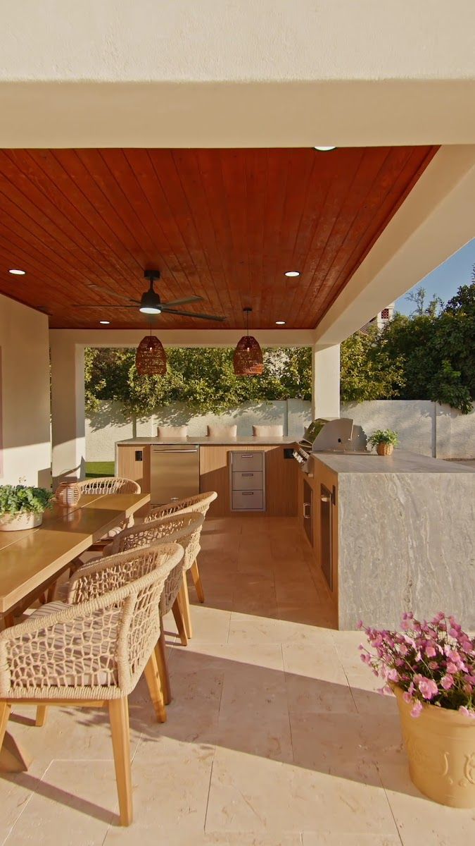 Covered patio with dining table and outdoor kitchen