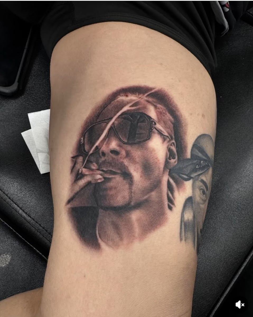 Black and grey realism portrait tattoo on an arm