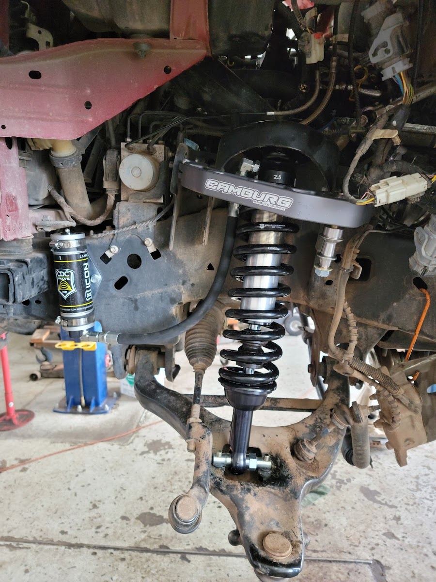 Coilover strut and suspension parts mounted on a vehicle up on the lift