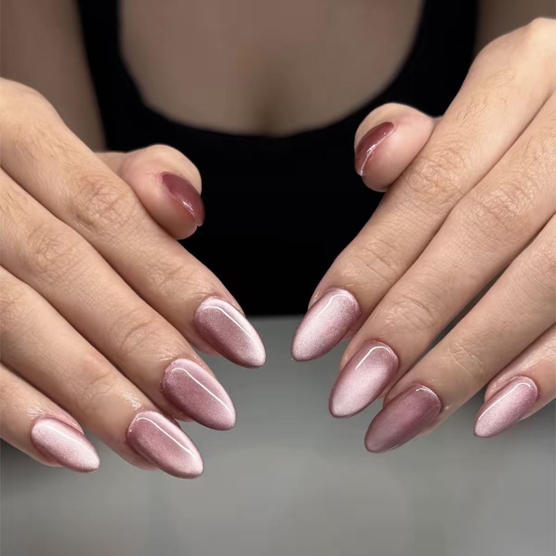 Soft pink and mauve almond nails with a pearl shimmer