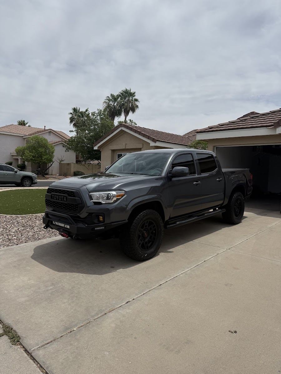 Gray pickup truck freshly washed in a driveway