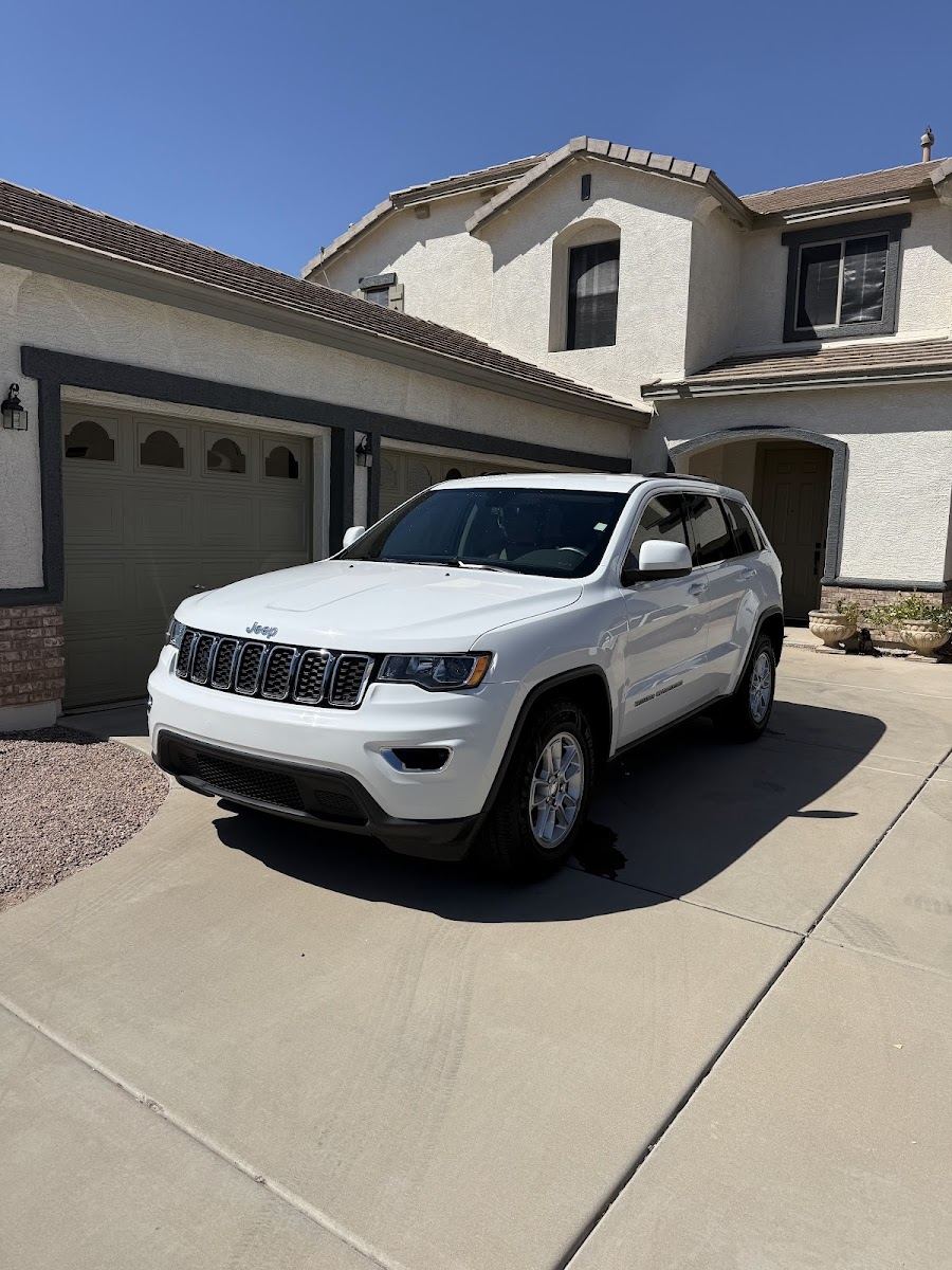 White SUV detailed and parked in front of a home