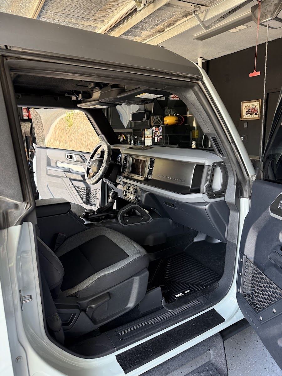 Freshly detailed interior of an SUV with the doors open in a garage