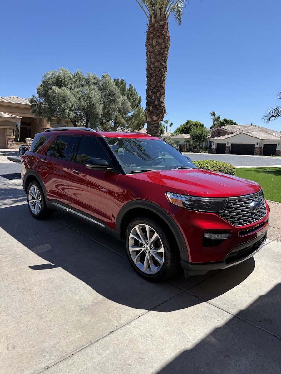 Red SUV glossy after detailing on a sunny street