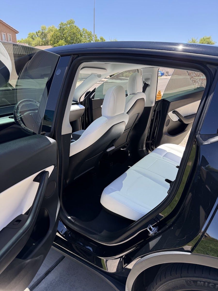 Spotless white leather seats inside an SUV after an interior detail