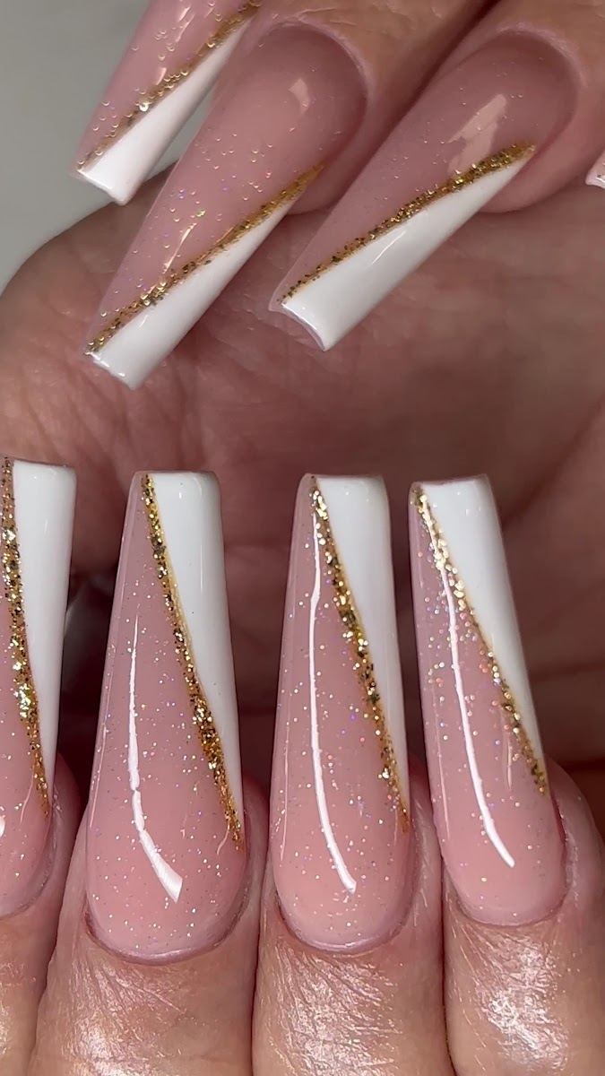 Long nude coffin nails with white tips and gold glitter stripes