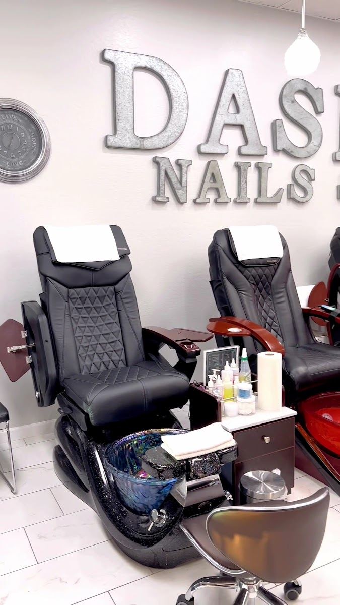 Black massage pedicure chairs with blue basins at the salon