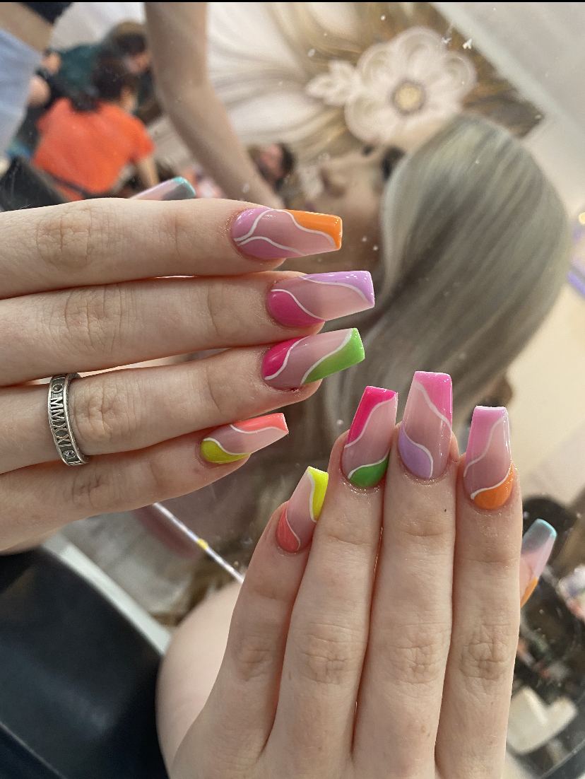 Square nails with bright pink, green and orange wave designs