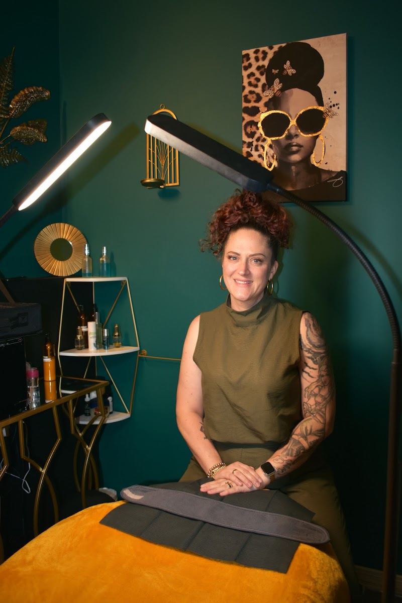 A team member seated in an emerald green treatment room