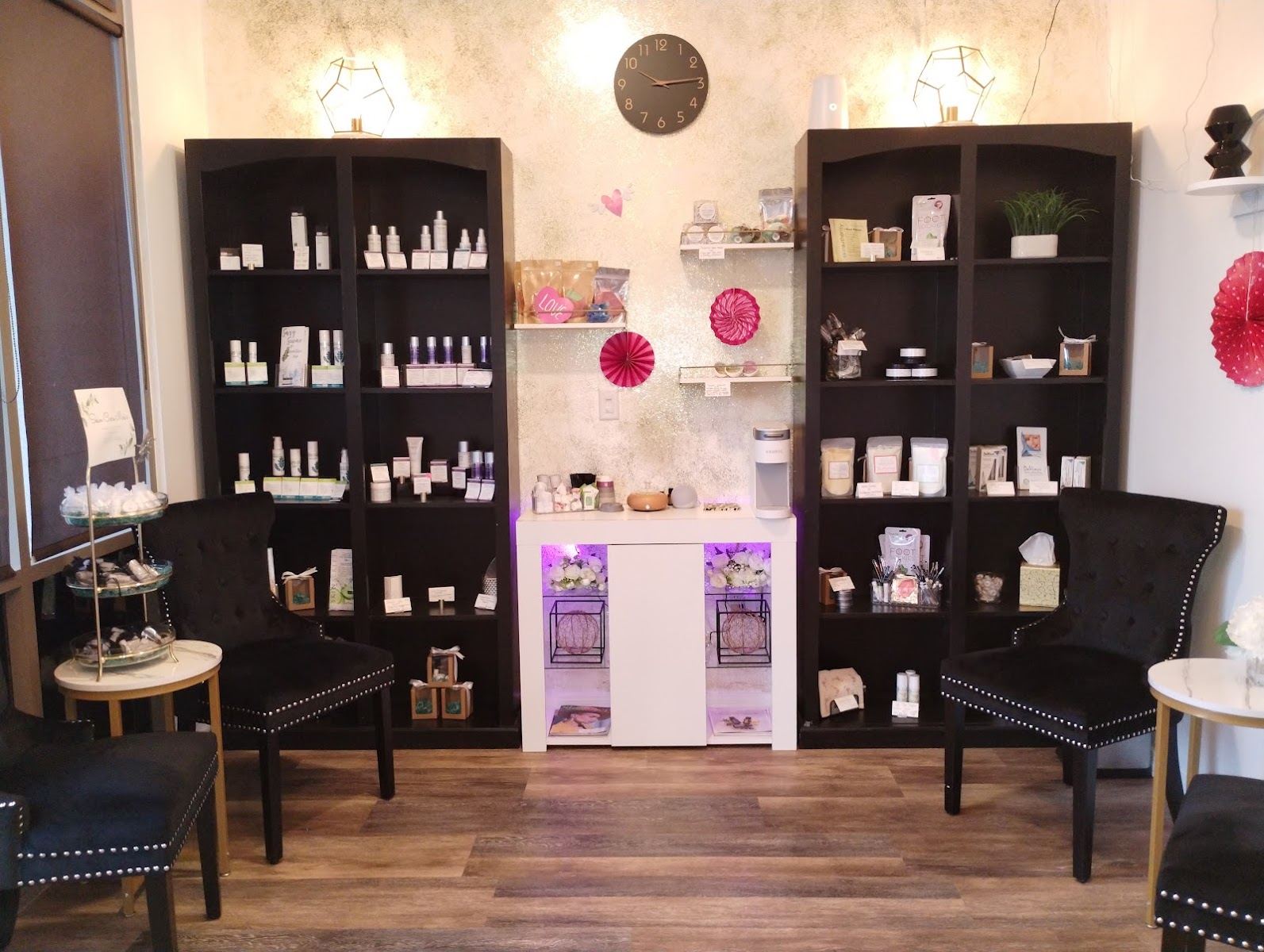 The Divine Design lobby with tufted black chairs and shelves of skin care