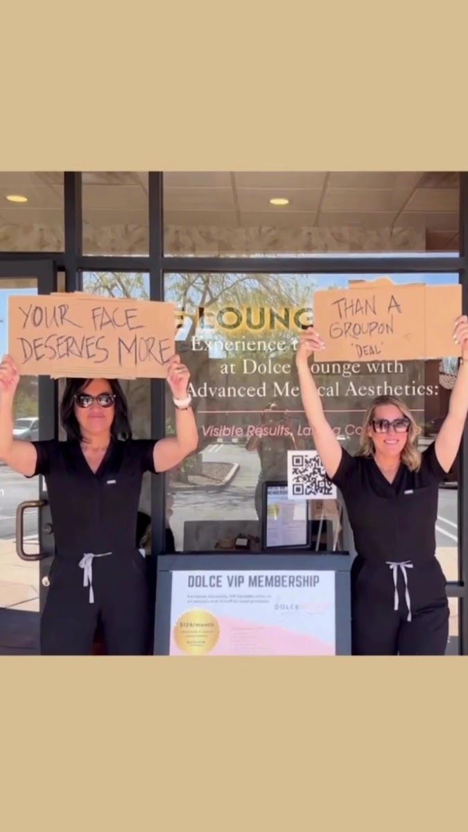 Dolce Lounge team members holding signs inside the studio