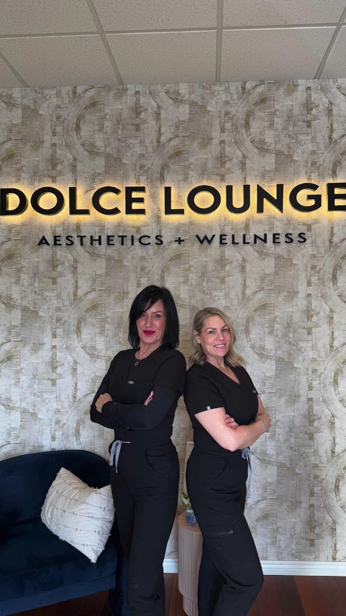 The Dolce Lounge team in front of the Dolce Lounge sign