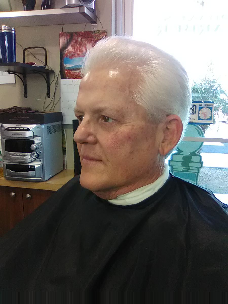 Older man with a classic silver side part