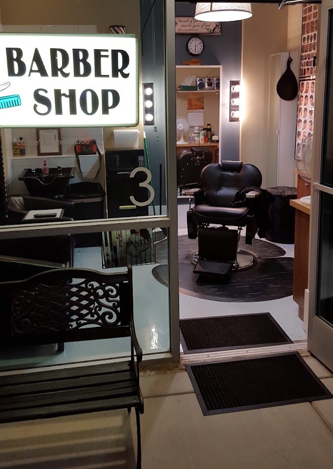 Inside Duane's Barber Studio: the barber chair seen through the studio's glass front