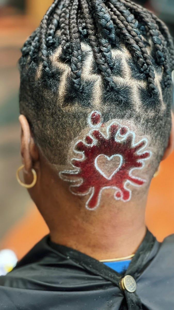 Braids with a red heart design shaved into the back