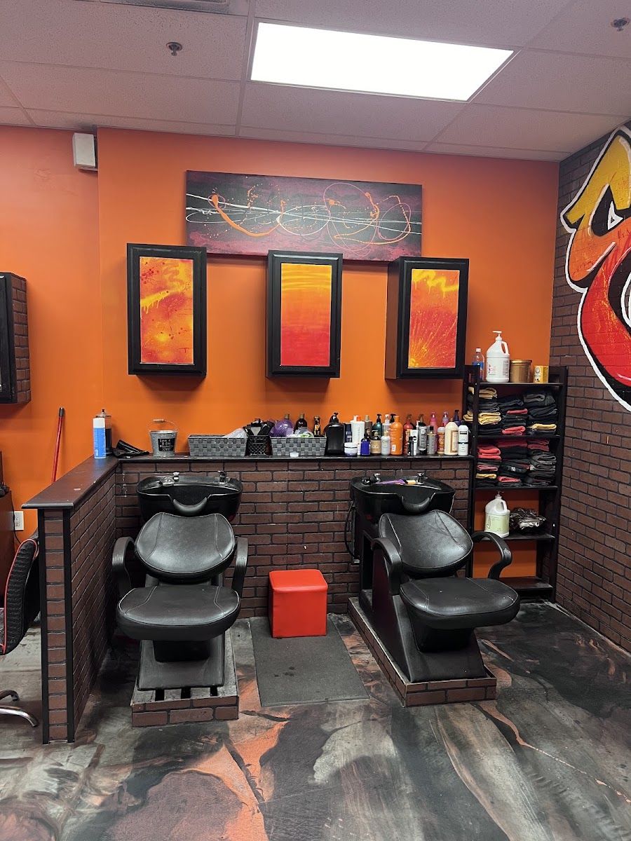 Shampoo chairs in front of the shop's orange wall