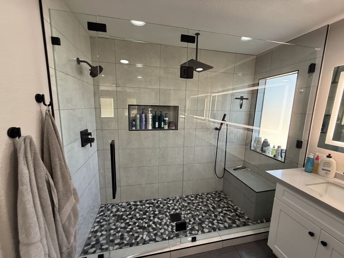 Walk-in glass shower with pebble floor, freshly cleaned