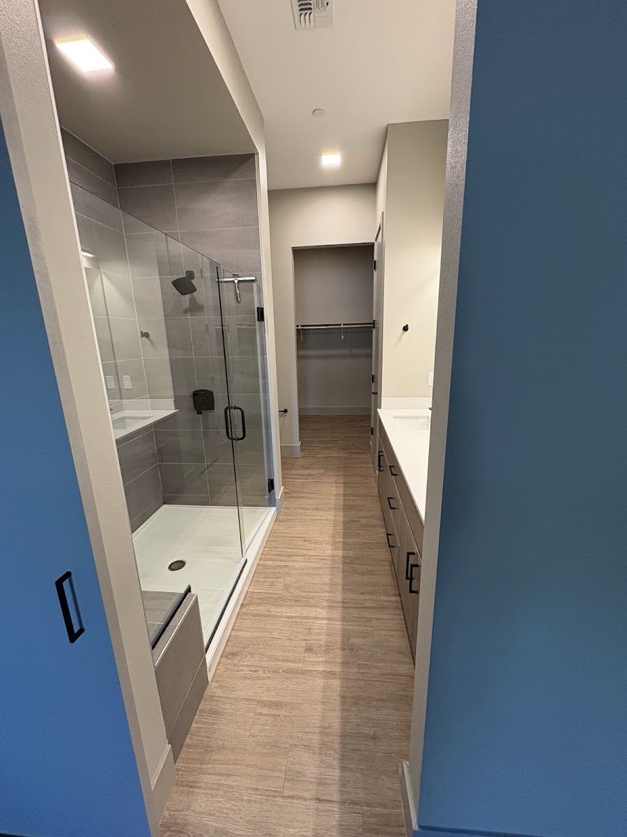 Bathroom hallway with a glass shower and walk-in closet