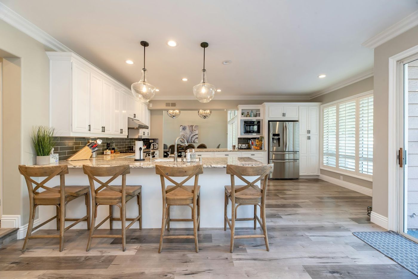 White kitchen with an island and wooden bar stools