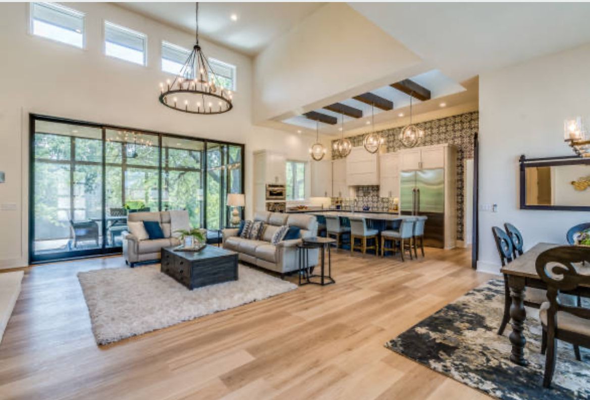 Open living and dining room with a chandelier and wood floors