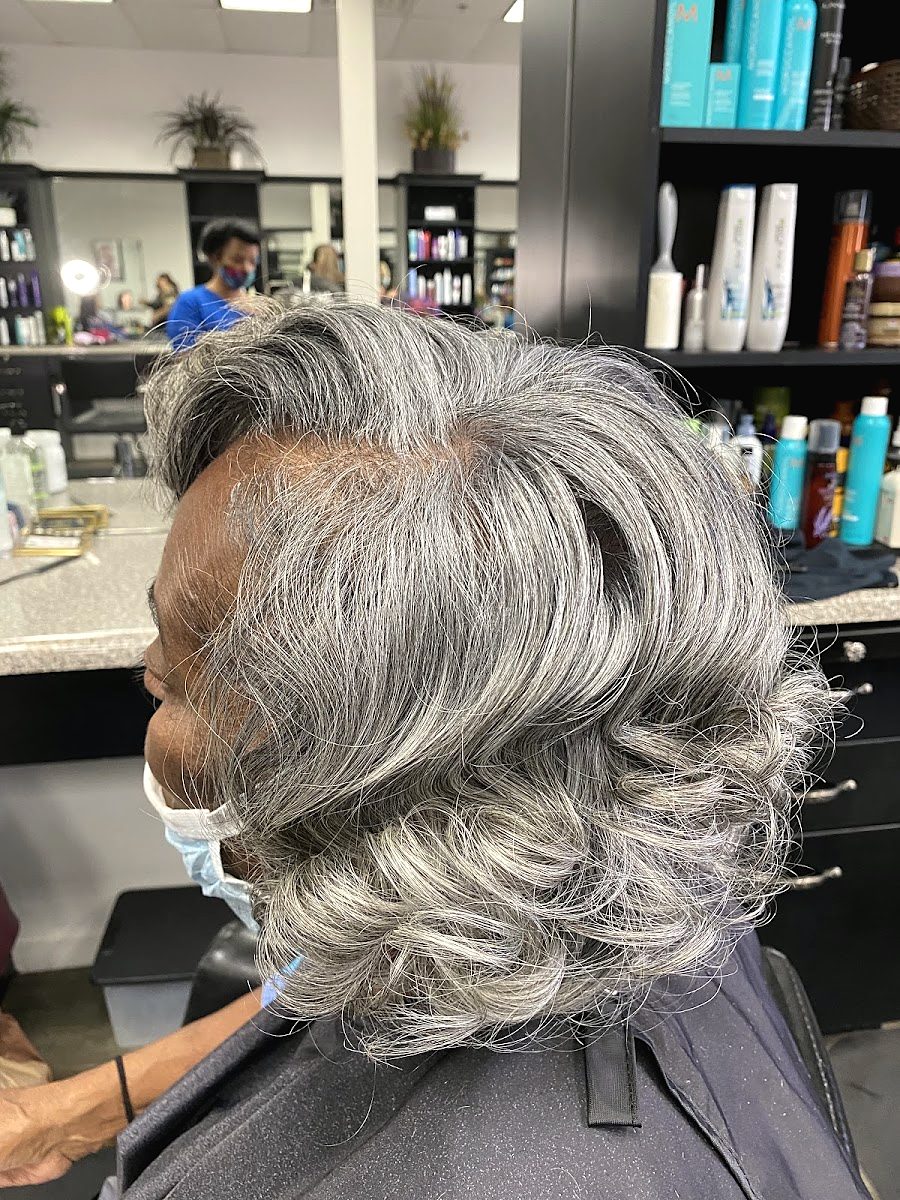 Side view of a short gray style brushed into soft waves