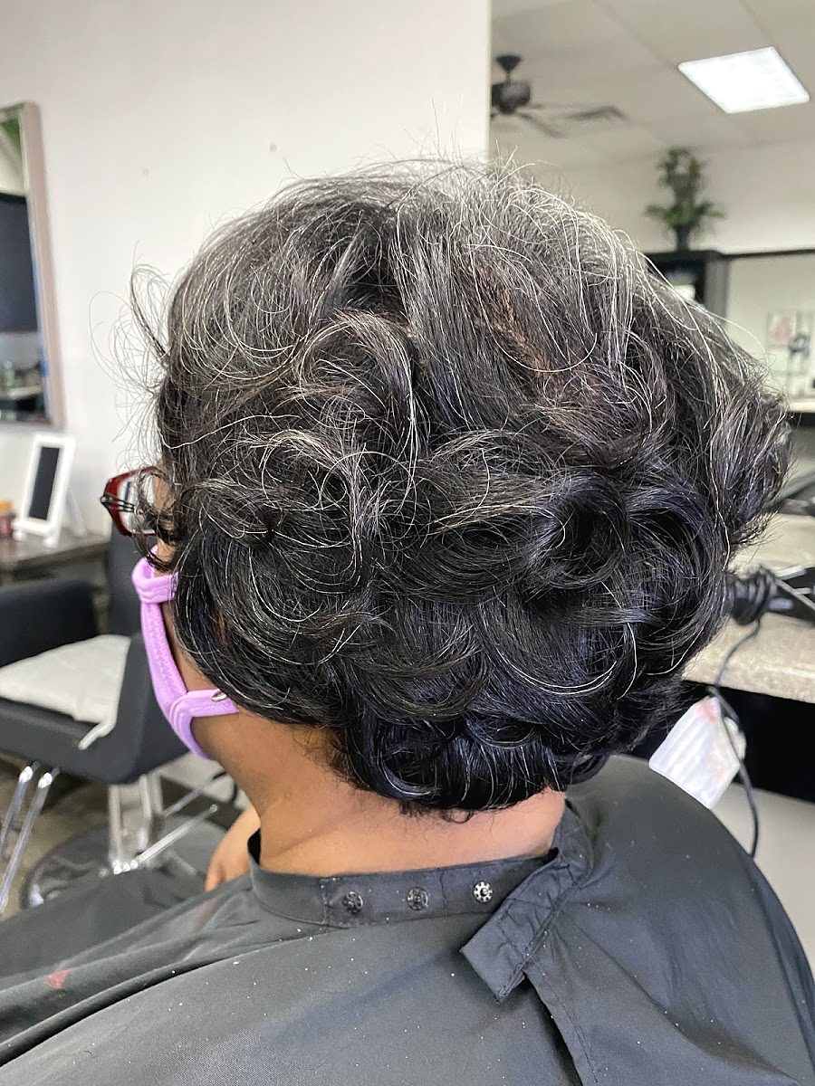 Back view of a short, curled set in salt and pepper hair