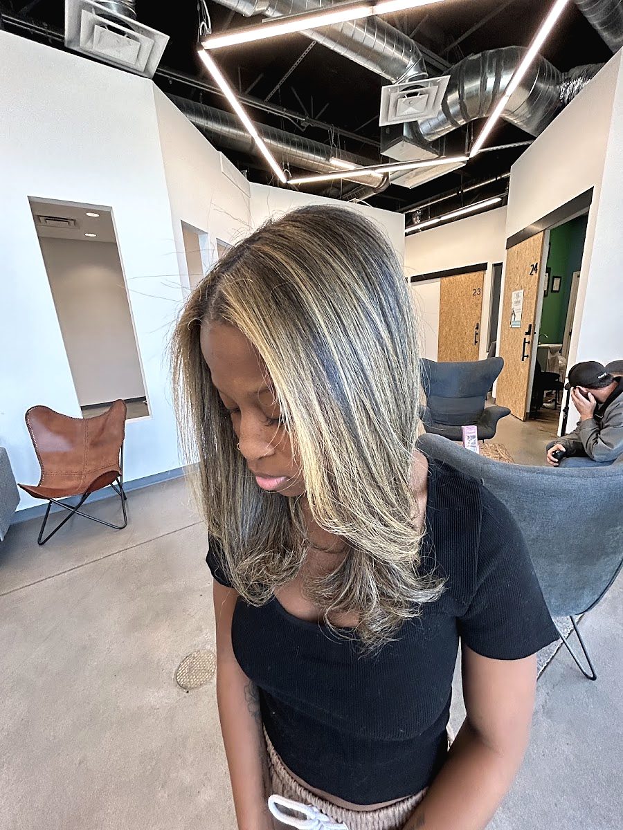 Client with long, straight hair with bright blonde face-framing pieces