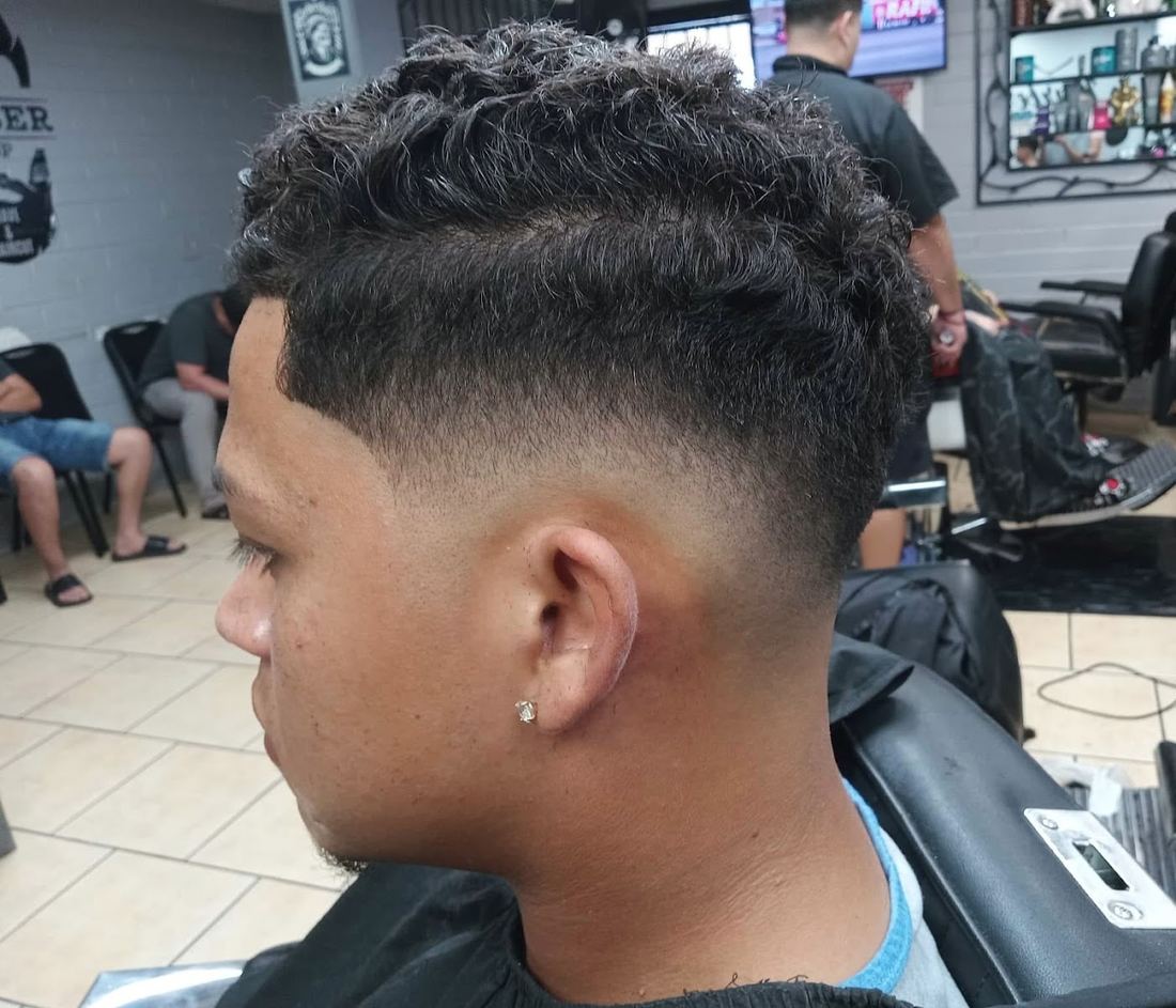 Curly textured top with a clean drop fade