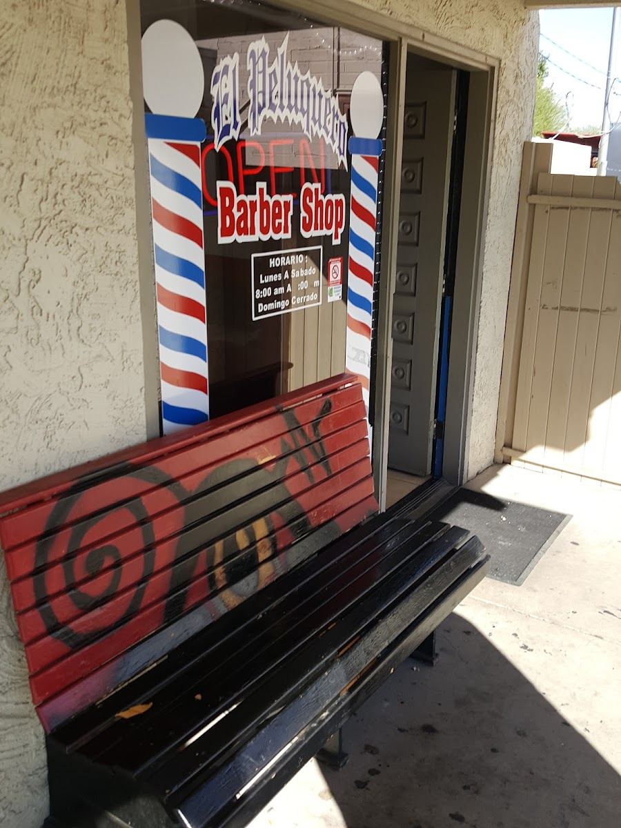 El Patrón storefront on E Broadway Rd with barber poles and the shop sign on the door