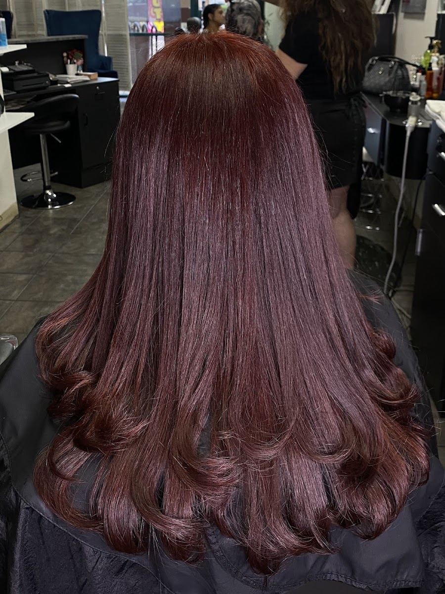 Long burgundy hair finished with bouncy curled ends
